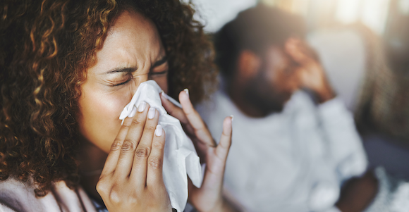 Woman blowing her nose