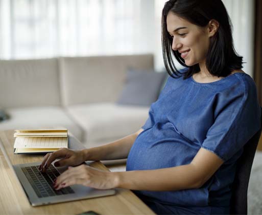 A pregnant woman at the computer