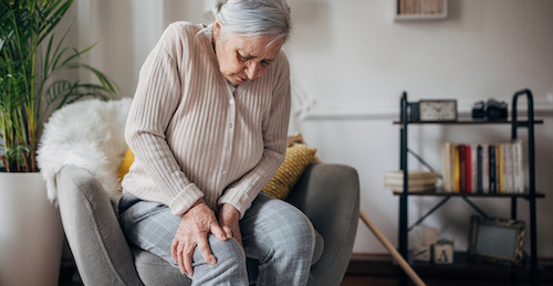 Woman clutching knee