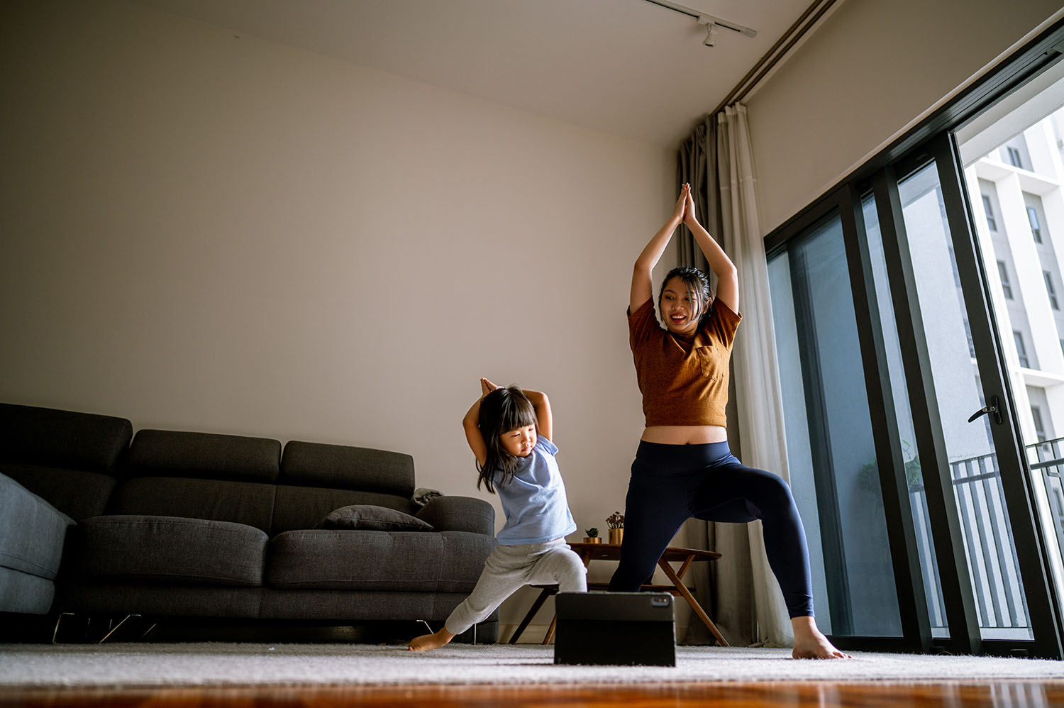 Woman doing yoga with child