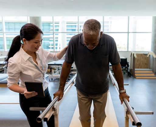 A specialist helping a man work on his balance