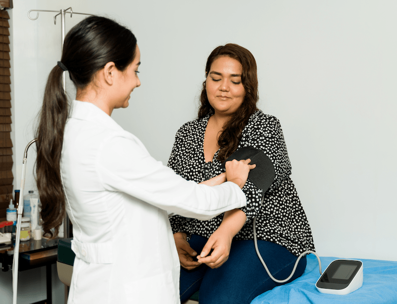 A doctor taking a patient's blood pressure