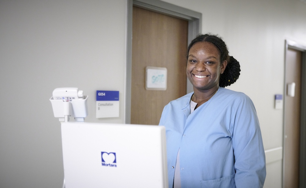 Technologist smiling in hallway