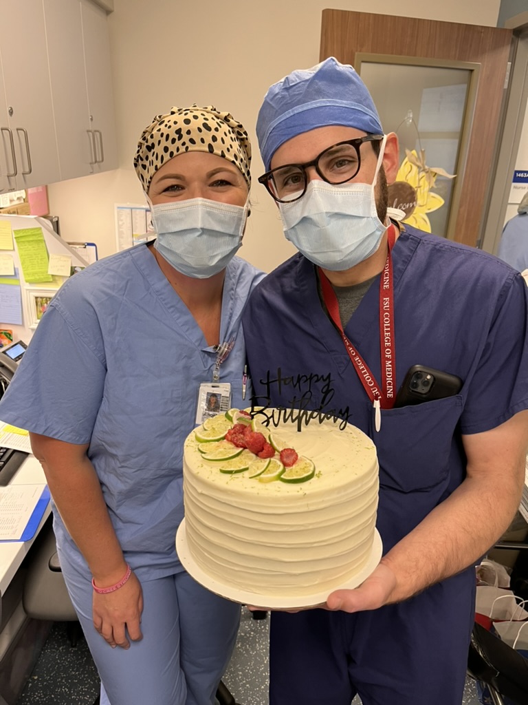 Angie and surgeon holding cake