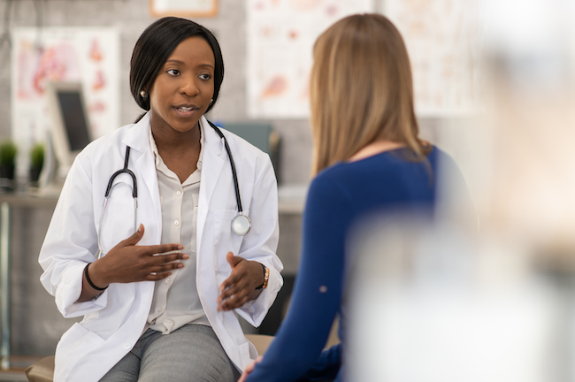 Gynecologist speaking to patient