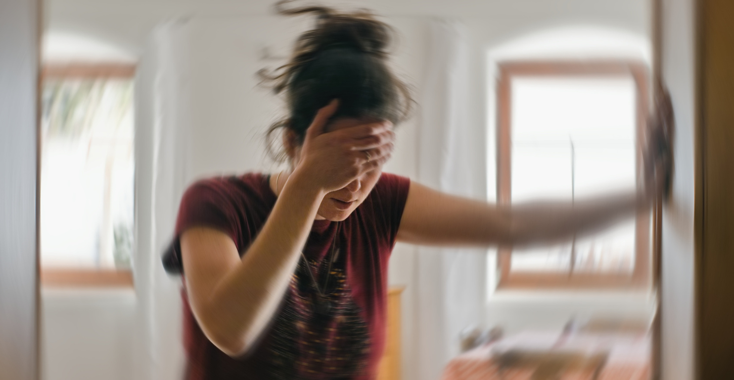 Woman feeling dizzy in house