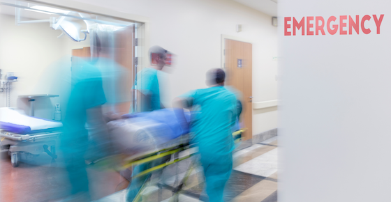 nurses wheeling patient in to the emergency room