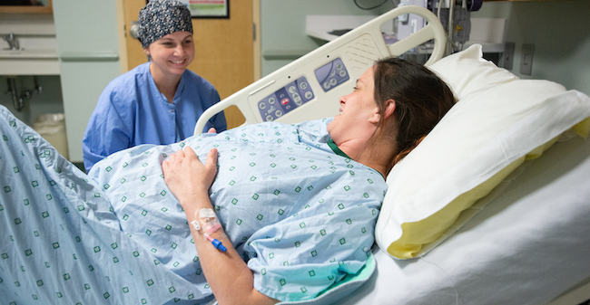 Woman in labor with a nurse