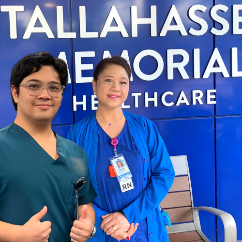 Nelly and her son in front of TMH sign