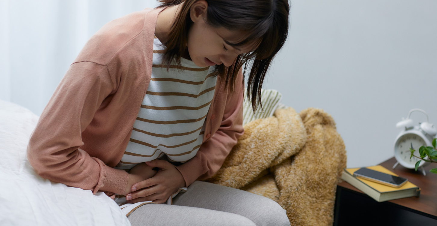 Woman clutching her abdomen