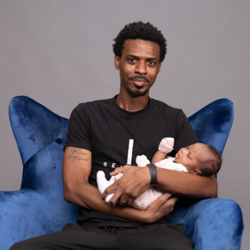 Troy holding his child