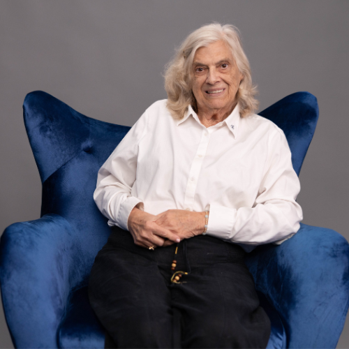 Camilla sitting in a blue chair smiling