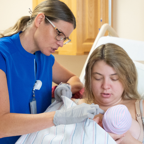 Lactation consultant helping a new mom breast feed