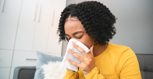 Woman blowing her nose