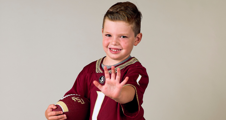 kickoff kid holding football