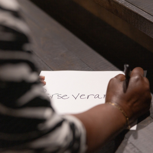 Sonia writing perseverance on a piece of paper