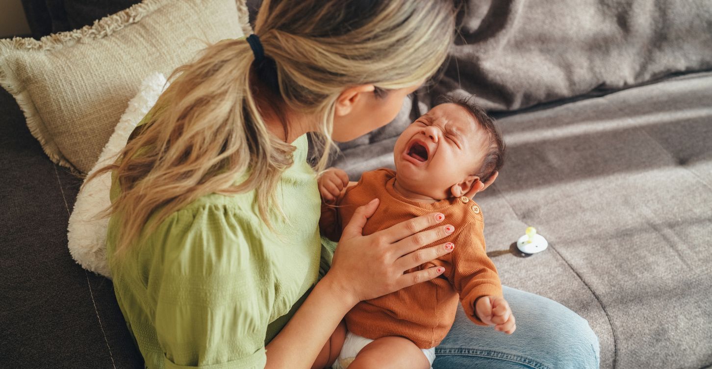 Mother holding sick baby