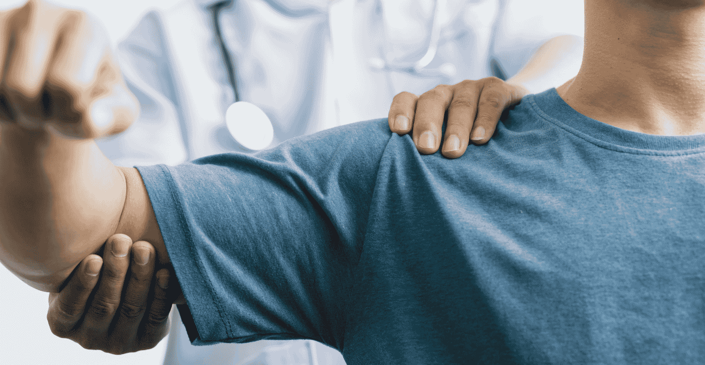 Man having his shoulder checked by a Doctor