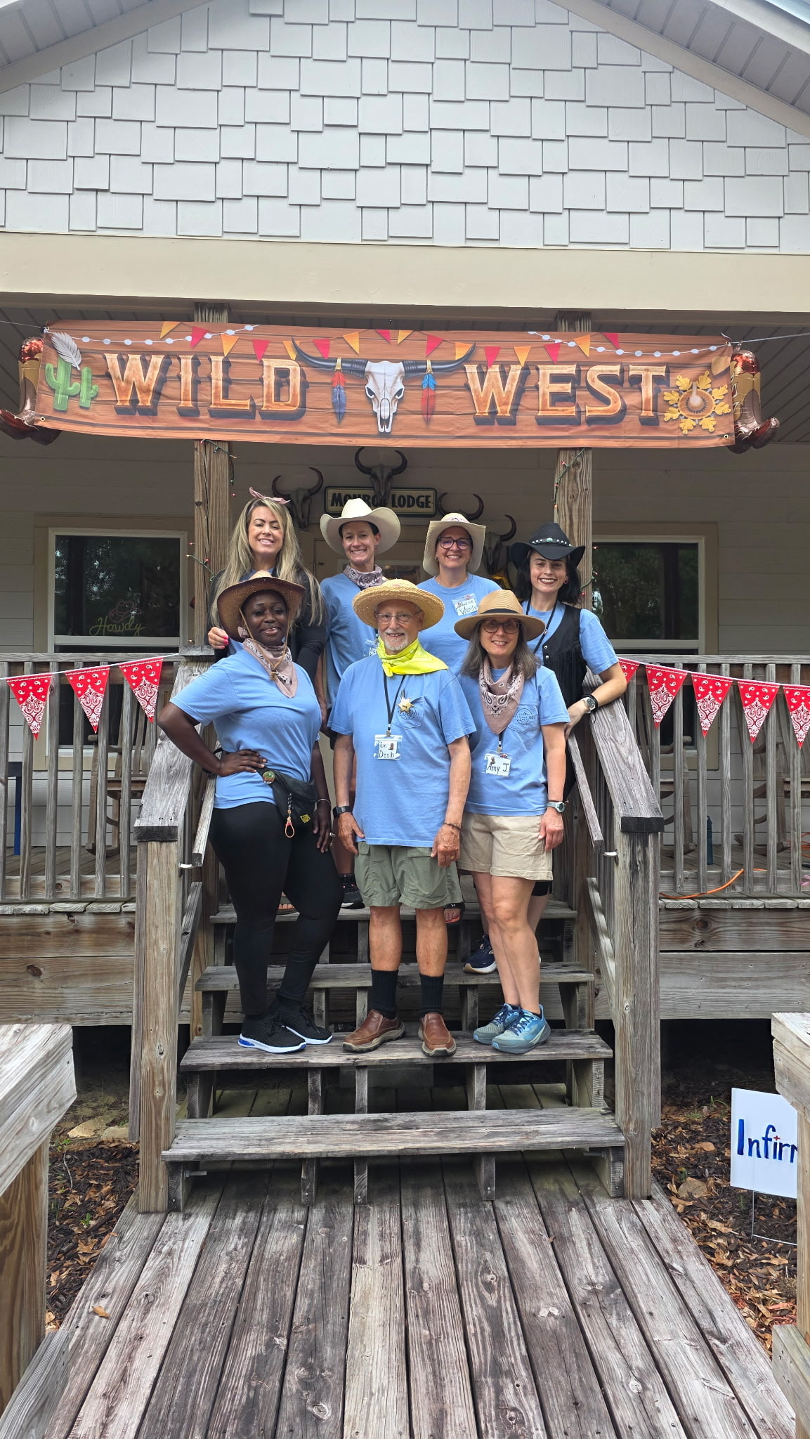 Camp staff gather for a Wild West-themed activity.