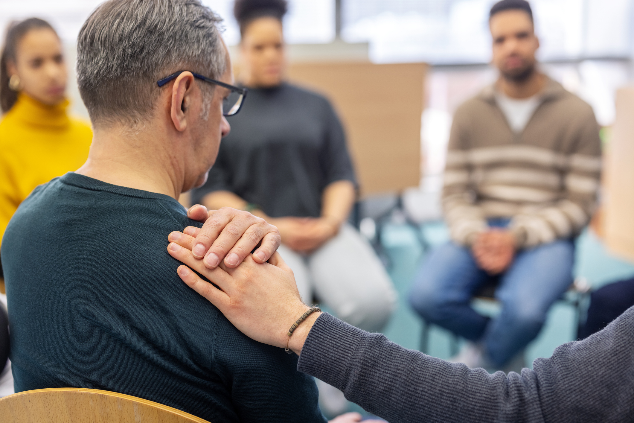 Participants supporting one another during group therapy