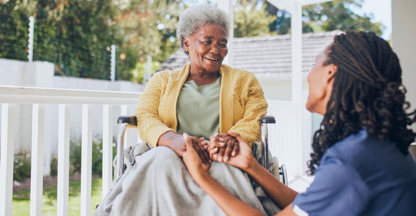 Home nurse speaking to an Elderly woman in a wheelchair