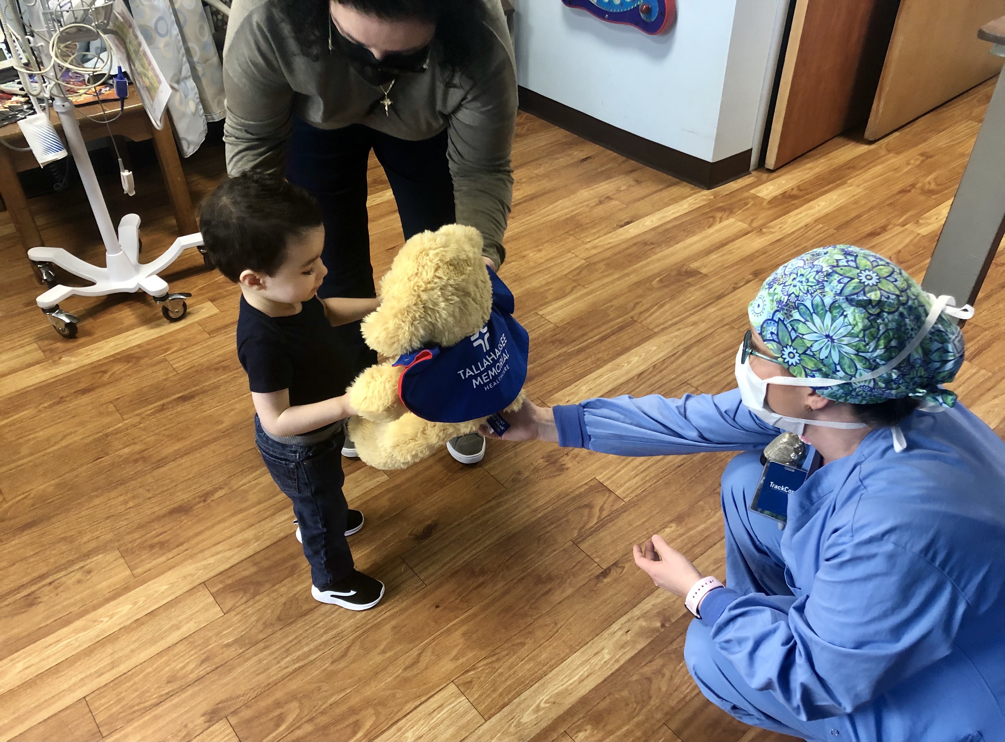 TMH SuperPup comforting a pediatric patient