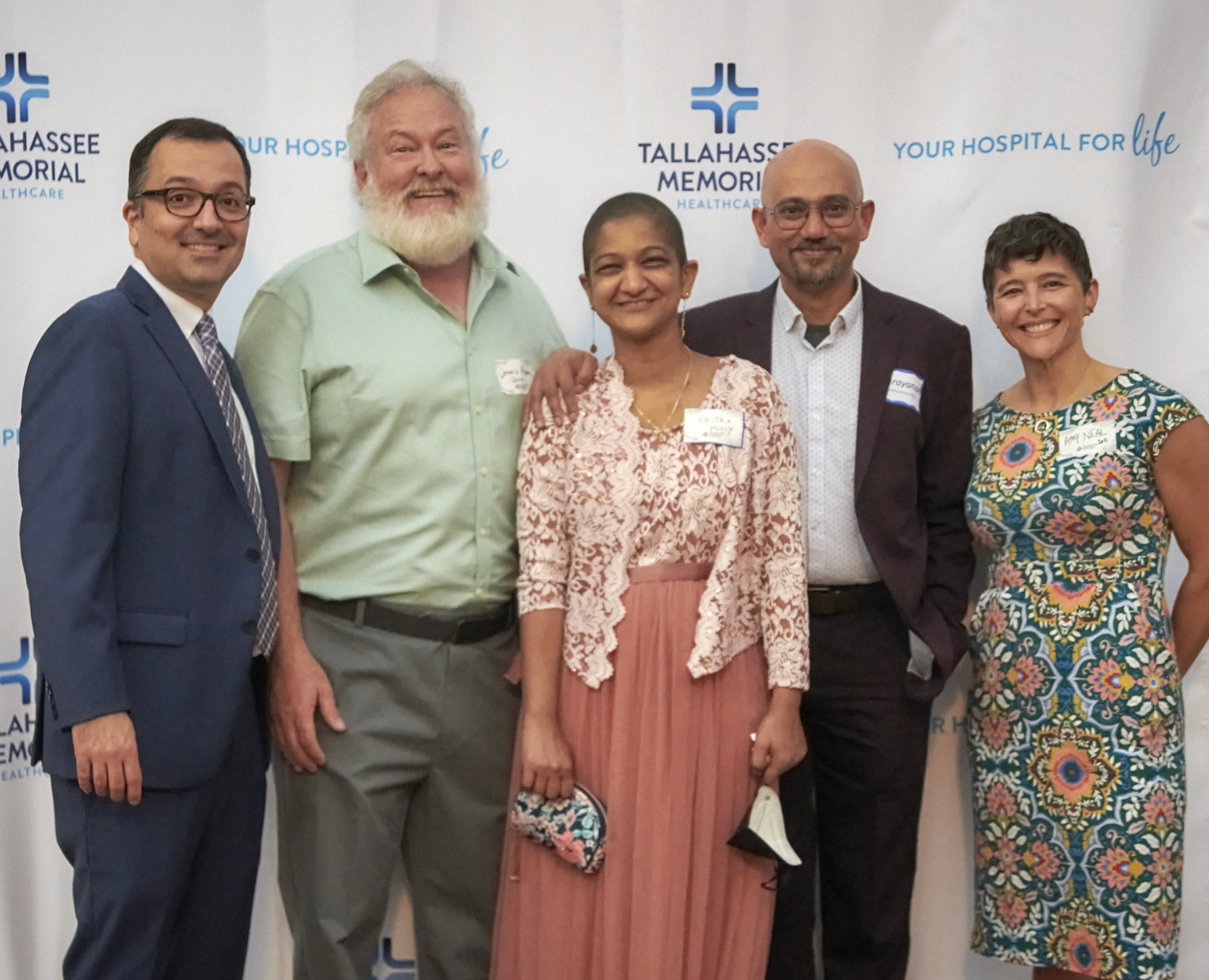 Four former residents smiling at the FMRP Reunion