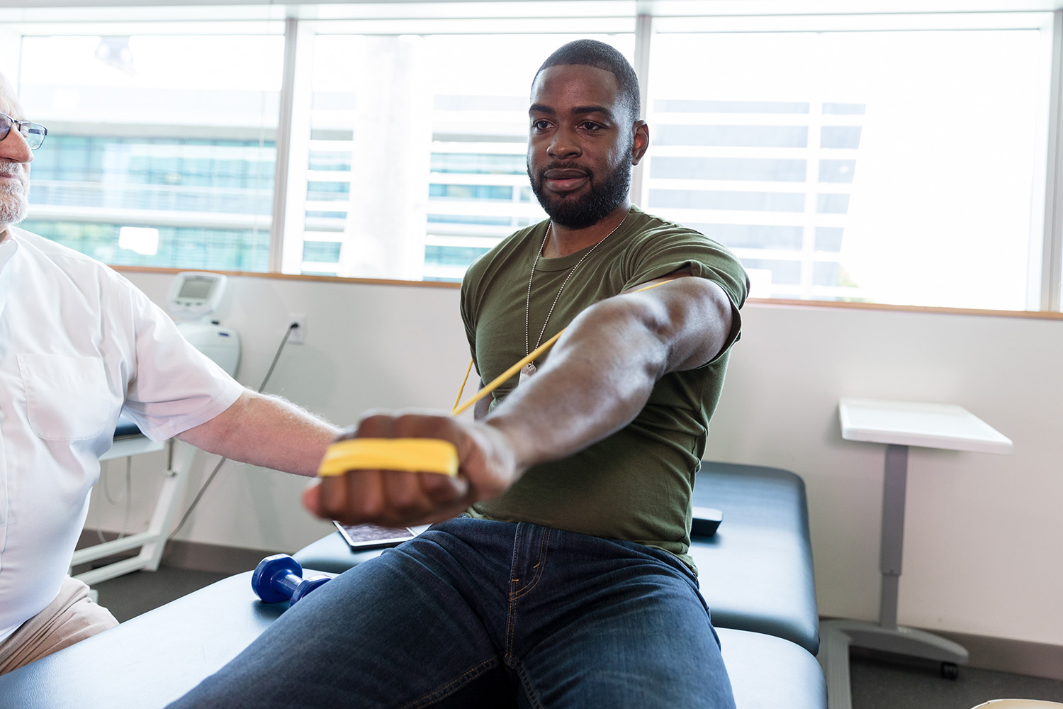 A nurse taking a man's arm in her hand