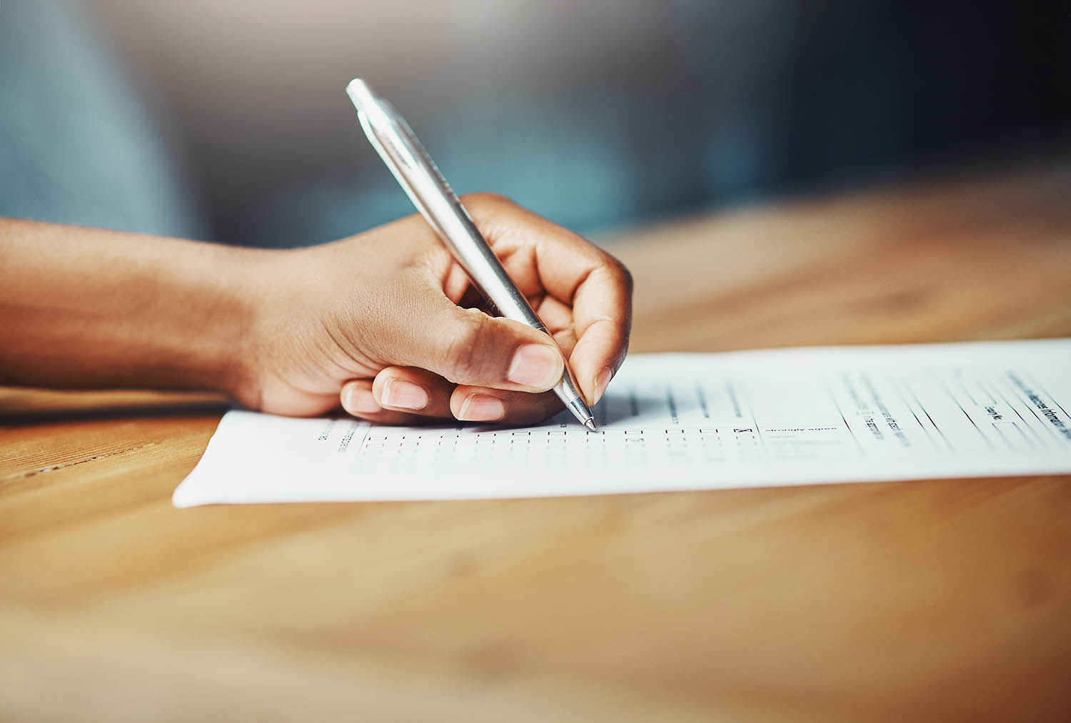 A hand writing on paper