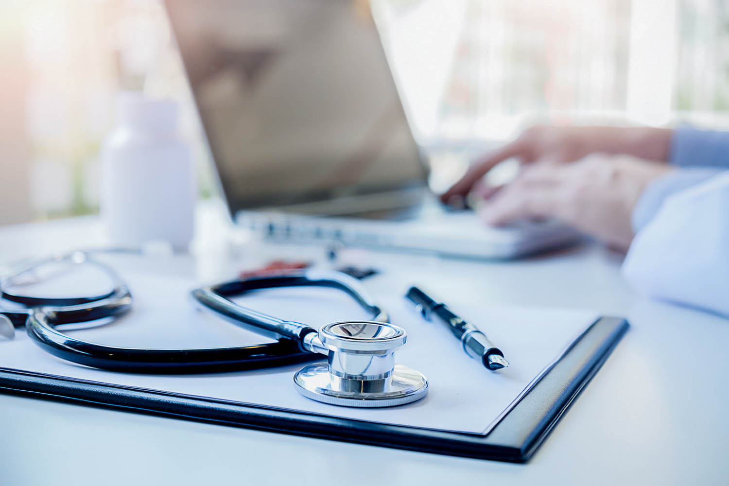 A stethoscope on top of a notepad