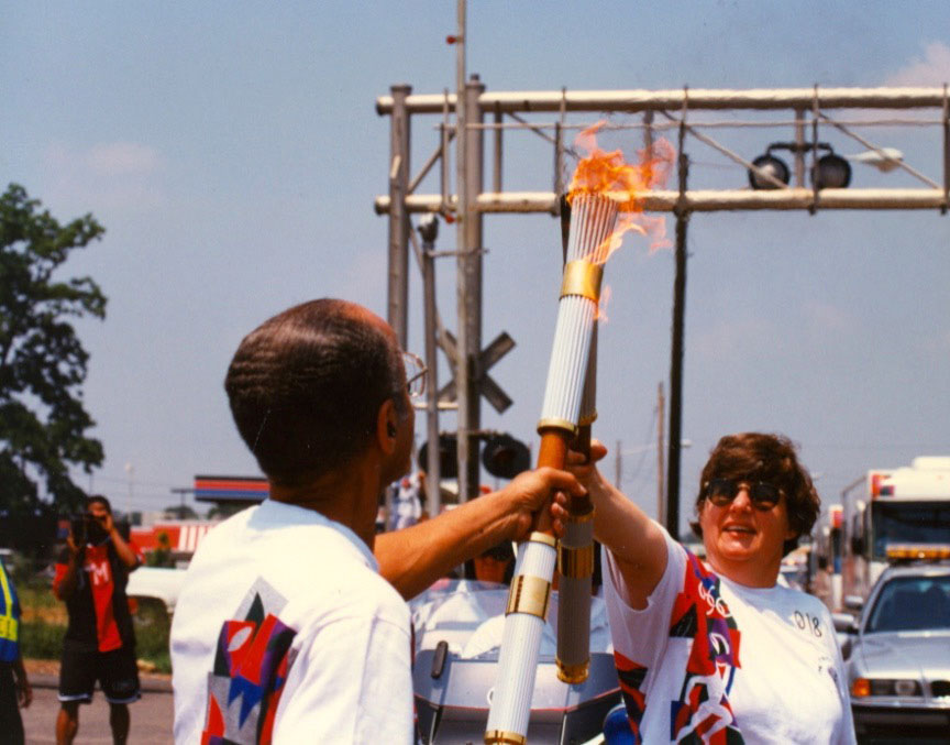 Dr. Brickler carries the Olympic Torch in 1996