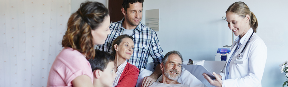 A doctor reviewing results with a man and his family