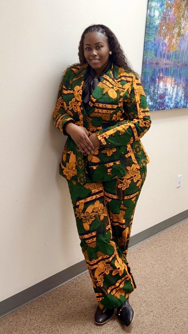 Cierra smiles for a photo in the hallway