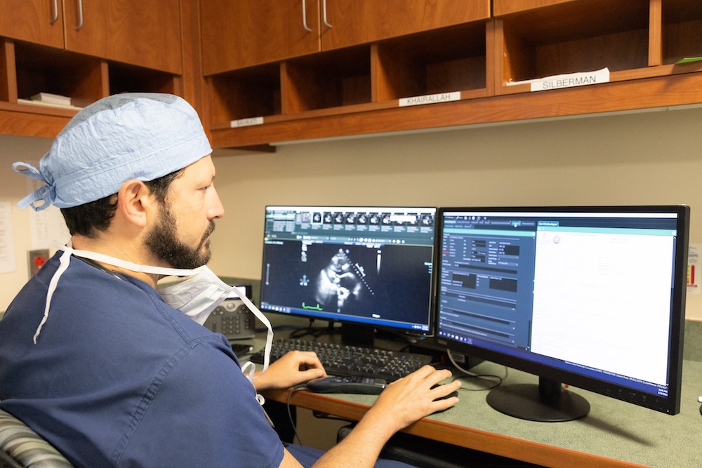 Gregory Hartlage, MD looking at computer